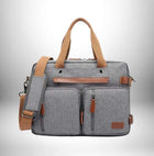 sac à dos convertible gris avec des poignées marron et une bandoulière.
— vue 7