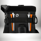 A close-up shot of a black golf bag with two golf tees. The tees are orange and white and held in place by a black strap. — vue 6