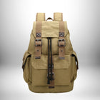 Un sac à dos en toile beige avec des sangles marron et des boucles en métal.
 — vue 1