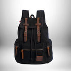 Un sac à dos de couleur noire avec des accents en cuir marron.
 — vue 1
