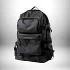 Un sac à dos ergonomique noir avec plusieurs poches, des sangles et une poignée supérieure. — vue 6