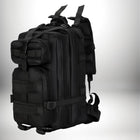 Un sac à dos noir de style militaire, potentiellement un sac infirmier, avec plusieurs poches et attaches. — vue 1