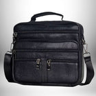 Sac bandoulière homme cuir souple noir avec plusieurs compartiments zippés, une poignée et une bandoulière amovible.
 — vue 1
