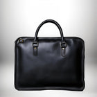 Un sac à main noir avec une poignée et des détails métalliques. — vue 1