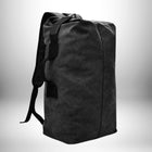 Un sac à dos noir en toile avec une sangle d'épaule. — vue 5